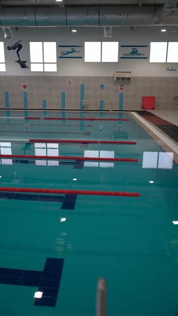 View of indoor swimming pool with lane markers in Qatar. View of indoor swimming pool with lane markers in Qatar.