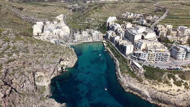 Aerial view of Xlendi Bay with turquoise water and cliffs in Malta. Aerial view of Xlendi Bay with turquoise water and cliffs in Malta.