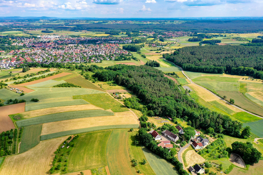 Aerial view of the town featuring a patchwork of agricultural fields and lush green forests Neunkirchen am Brand Bavaria Germany. Aerial view of the town featuring a patchwork of agricultural fields and lush green forests Neunkirchen am Brand Bavaria Germany.