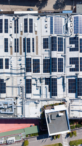 Aerial view of a food additive manufacturing plant roof featuring extensive solar panel arrays ventilation systems and industrial piping in Milan Lombardy Italy. Aerial view of a food additive manufacturing plant roof featuring extensive solar panel arrays ventilation systems and industrial piping in Milan Lombardy Italy.