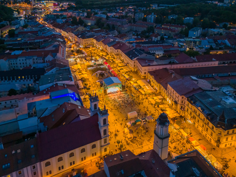 Aerial view of Radvansky jarmok traditional market illuminated at night with crowds of people and historic buildings in the town square of Banska Bystrica Banskobystricky kraj Slovakia.