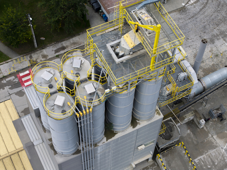 Aerial view of the asphalt plant with industrial silos yellow metal railings and pipes in Krakow Lesser Poland Voivode Poland.