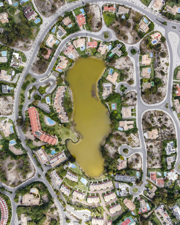 Aerial view of an exclusive luxury village with expensive villas and hotels on Troia Peninsula along the beach with artificial lake Setubal Portugal.