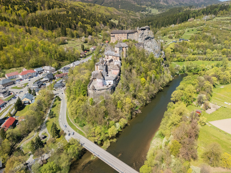 Aerial view of Orava Castle perched on a high rock above the Orava river surrounded by lush green forests and a small village Dolny Kubin Zilinsky kraj Slovakia. Aerial view of Orava Castle perched on a high rock above the Orava river surrounded by lush green forests and a small village Dolny Kubin Zilinsky kraj Slovakia.