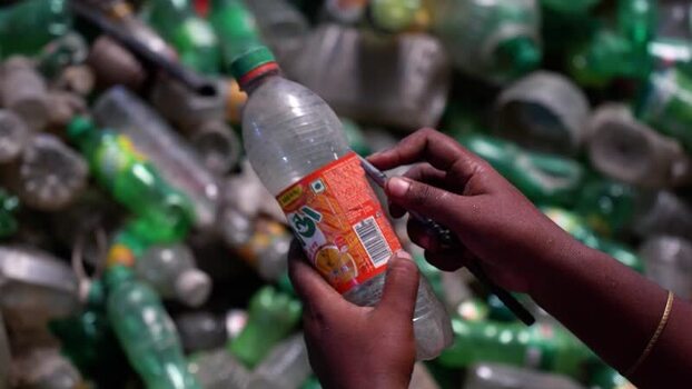 View of a worker sorting plastic bottles in Bogura Bangladesh. View of a worker sorting plastic bottles in Bogura Bangladesh.