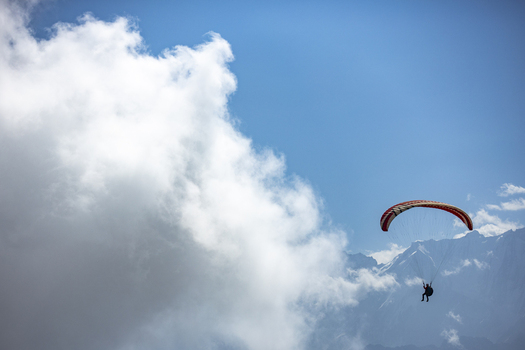 Aerial view of a paraglider soaring through the sky near the mountains of Booni Khyber Pakhtunkhwa Pakistan.