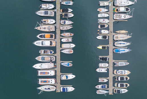 Aerial view of numerous sailboats and motorboats moored at wooden piers in the marina of Sopot Pomeranian Voivodeshi Poland. Aerial view of numerous sailboats and motorboats moored at wooden piers in the marina of Sopot Pomeranian Voivodeshi Poland.