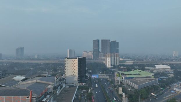 Bekasi Barat West Java Indonesia 20 June 2026 Aerial view of the urban landscape featuring modern high rise buildings a busy highway and dense infrastructure under a hazy sky. Bekasi Barat West Java Indonesia 20 June 2026 Aerial view of the urban landscape featuring modern high rise buildings a busy highway and dense infrastructure under a hazy sky.