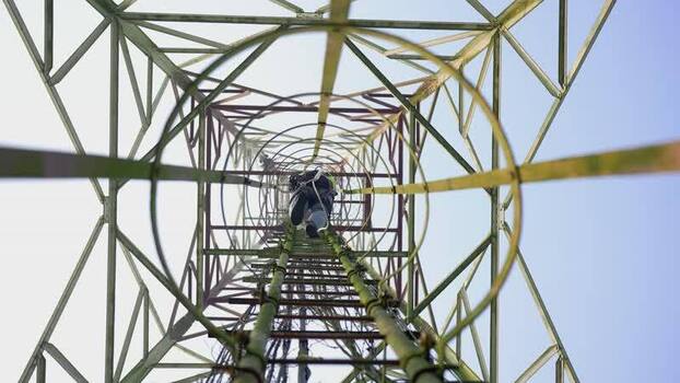 View of a technician climbing a telecommunications tower Bangladesh. View of a technician climbing a telecommunications tower Bangladesh.
