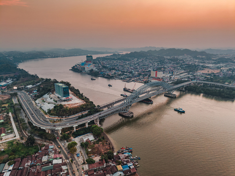 Aerial view of Jembatan Mahakam I spanning the Mahakam River with urban development and boats on the water Kecamatan Samarinda Seberang Kalimantan Timur Indonesia. Aerial view of Jembatan Mahakam I spanning the Mahakam River with urban development and boats on the water Kecamatan Samarinda Seberang Kalimantan Timur Indonesia.