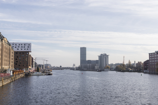 View of the Spree river flowing through the city with modern architecture and historic brick buildings under a bright sky Berlin Berlin Germany. View of the Spree river flowing through the city with modern architecture and historic brick buildings under a bright sky Berlin Berlin Germany.