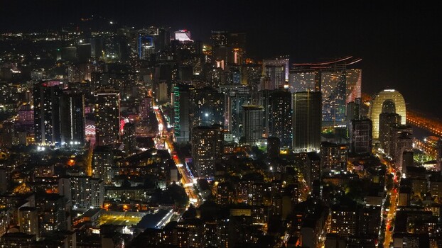 Batumi Georgia 17 September 2026 Aerial view of the illuminated city skyline at night featuring modern skyscrapers glowing street lights and coastal architecture along the Black Sea.