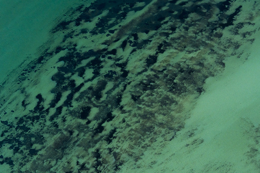 Aerial view of turquoise ocean patterns and sandbanks in the shallow waters of the coast in Shire of Shark Bay Western Australia Australia. Aerial view of turquoise ocean patterns and sandbanks in the shallow waters of the coast in Shire of Shark Bay Western Australia Australia.