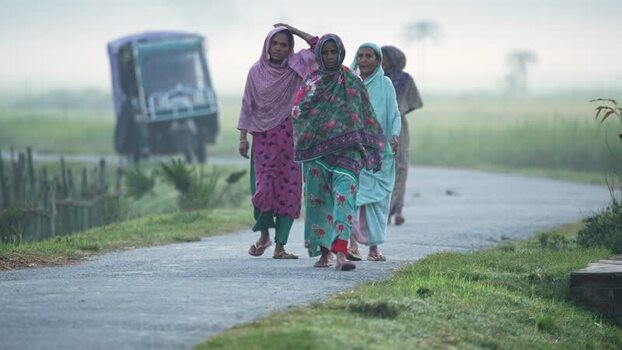 View of women walking on a rural road in Bogura Bangladesh. View of women walking on a rural road in Bogura Bangladesh.