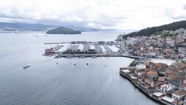 Aerial view of the historic coastal village of Combarro featuring its marina traditional stone houses and the Illa de Tambo in the bay Combarro Pontevedra Spain. Aerial view of the historic coastal village of Combarro featuring its marina traditional stone houses and the Illa de Tambo in the bay Combarro Pontevedra Spain.