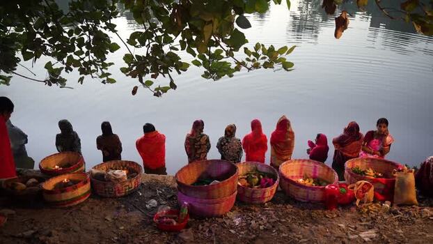 View of women with ritual offerings by the river Bangladesh. View of women with ritual offerings by the river Bangladesh.