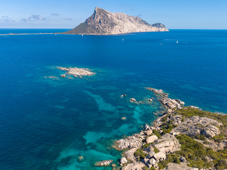 Aerial view of the rocky coastline of San Teodoro with turquoise waters and the island of Tavolara in the background in San Teodoro Sardegna Italy.