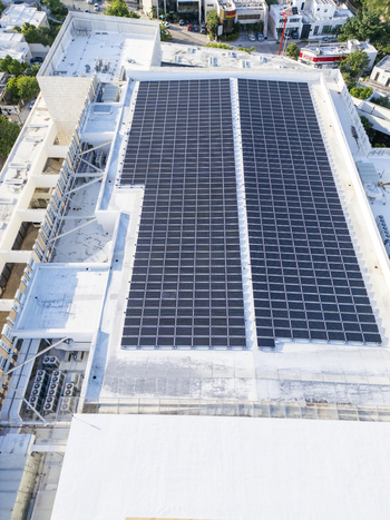 Aerial view of Centro Internacional de Congresos de Yucatan featuring a large array of solar panels on the rooftop with surrounding urban infrastructure in Merida Yucatan Mexico. Aerial view of Centro Internacional de Congresos de Yucatan featuring a large array of solar panels on the rooftop with surrounding urban infrastructure in Merida Yucatan Mexico.