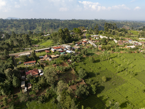 Aerial view of a rural settlement nestled amidst verdant green fields and dense forests under a bright sky Nyeri Nyeri Kenya. Aerial view of a rural settlement nestled amidst verdant green fields and dense forests under a bright sky Nyeri Nyeri Kenya.