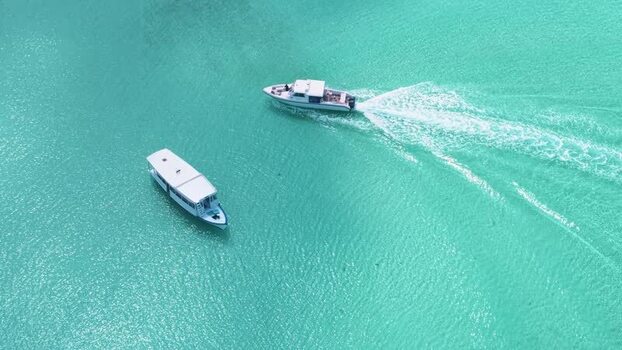 Aerial view of two white boats on turquoise tropical waters Maldives. Aerial view of two white boats on turquoise tropical waters Maldives.