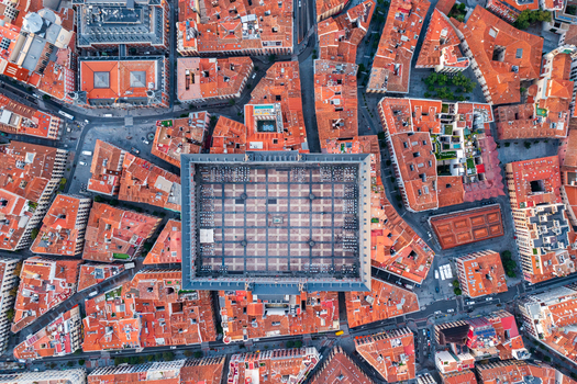 Aerial view of Plaza Mayor surrounded by historic red tiled rooftops and narrow streets in the city center of Madrid Community of Madrid Spain.