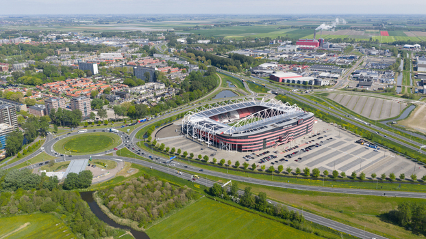 Alkmaar Netherlands 05 May 2026 Aerial view of AFAS stadium with its modern architecture surrounding parking lots and green fields under a clear sky.