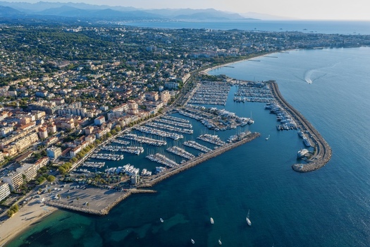 Aerial view of Port Vauban marina filled with yachts and boats adjacent to the historic town along the Mediterranean coastline in Antibes Provence Alpes Cote d Azur France. Aerial view of Port Vauban marina filled with yachts and boats adjacent to the historic town along the Mediterranean coastline in Antibes Provence Alpes Cote d Azur France.