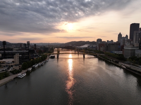 Pittsburgh Pennsylvania United States 26 July 2026 Aerial view of the Pittsburgh skyline at sunset with the Allegheny River and the yellow Roberto Clemente Bridge.