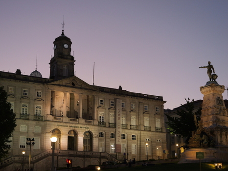 View of Palacio da Bolsa at dusk with its neoclassical architecture and a prominent statue in the foreground in Porto Porto District Portugal. View of Palacio da Bolsa at dusk with its neoclassical architecture and a prominent statue in the foreground in Porto Porto District Portugal.