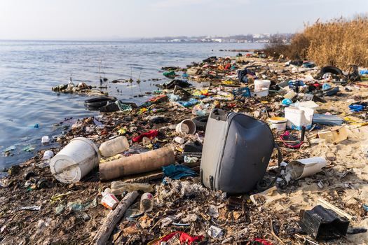 View of Lake Varna shoreline heavily polluted with plastic waste discarded items and debris scattered across the sand and water edge Varna Bulgaria. View of Lake Varna shoreline heavily polluted with plastic waste discarded items and debris scattered across the sand and water edge Varna Bulgaria.