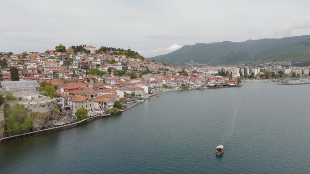 Aerial view of the historic town of Ohrid with its traditional red roofed houses along the shore of Lake Ohrid surrounded by mountains Ohrid Municipality of Ohrid North Macedonia. Aerial view of the historic town of Ohrid with its traditional red roofed houses along the shore of Lake Ohrid surrounded by mountains Ohrid Municipality of Ohrid North Macedonia.