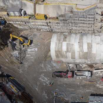 Aerial view of a construction site featuring an excavator a large tunnel segment and trucks in Istanbul Istanbul Turkiye.