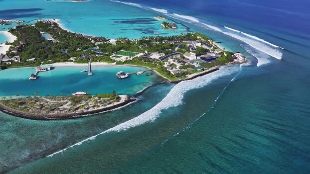 Aerial view of a resort island with turquoise water Maldives.