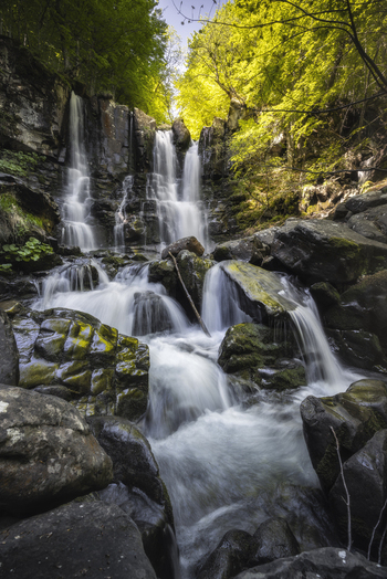 View of cascading waterfalls tumble down moss covered rocks a symphony of nature s power and serenity in the lush embrace of the forest Lizzano In Belvedere Emilia Romagna Italy. View of cascading waterfalls tumble down moss covered rocks a symphony of nature s power and serenity in the lush embrace of the forest Lizzano In Belvedere Emilia Romagna Italy.