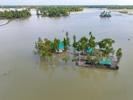 Aerial view of houses surrounded by floodwaters in the rural landscape of Banshkhali Upazila Chittagong Division Bangladesh. Aerial view of houses surrounded by floodwaters in the rural landscape of Banshkhali Upazila Chittagong Division Bangladesh.
