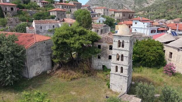 Aerial view of the historic stone bell tower in Qeparo Albania.