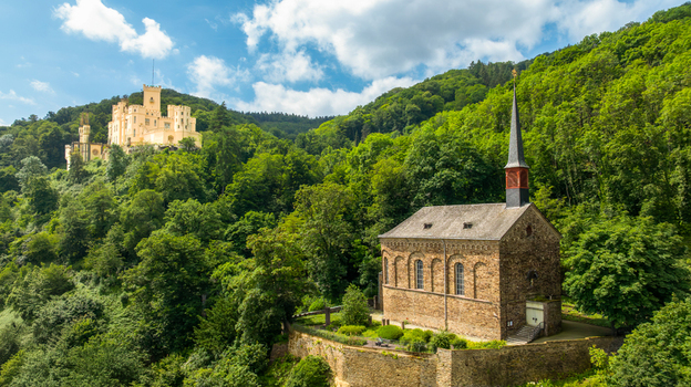 Aerial view of the historic St. Menas church and Stolzenfels Castle surrounded by lush green forests on a sunny day in Koblenz Rheinland Pfalz Germany. Aerial view of the historic St. Menas church and Stolzenfels Castle surrounded by lush green forests on a sunny day in Koblenz Rheinland Pfalz Germany.