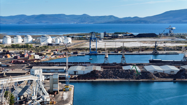 Aerial view of Port of Ploce with industrial cranes cargo containers storage tanks and ships docked at the harbor in Croatia. Aerial view of Port of Ploce with industrial cranes cargo containers storage tanks and ships docked at the harbor in Croatia.