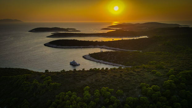 Hvar Croatia 21 August 2023 Aerial view of Vinogradisce bay on the Pakleni Islands with boats anchored in the calm water during a golden sunset. Hvar Croatia 21 August 2023 Aerial view of Vinogradisce bay on the Pakleni Islands with boats anchored in the calm water during a golden sunset.