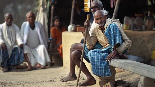 View of elderly men sitting outside a rural home in Patna India.