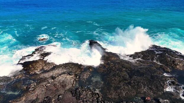 Aerial view of waves crashing on Kalaemamo coast United States.