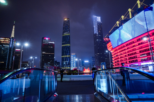 Guangzhou China 24 February 2024 View of the illuminated skyline and modern skyscrapers at night from an escalator in Guangzhou Guangdong Province China. Guangzhou China 24 February 2024 View of the illuminated skyline and modern skyscrapers at night from an escalator in Guangzhou Guangdong Province China.