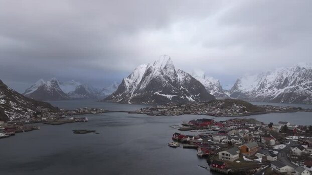 Aerial view of Lofoten mountains and coastal village in Norway.