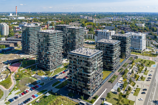 Aerial view of modern high rise apartment buildings surrounded by green spaces and urban infrastructure in Katowice Silesian Voivodeship Poland.