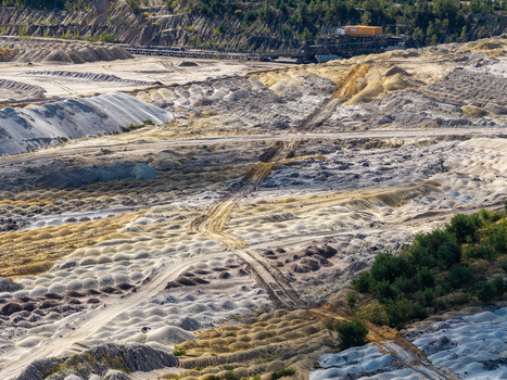 Aerial view of Tagebau Welzow Sud brown coal open pit mine showing vast excavated terrain sandy soil textures and industrial mining equipment in Spremberg Brandenburg Germany. Aerial view of Tagebau Welzow Sud brown coal open pit mine showing vast excavated terrain sandy soil textures and industrial mining equipment in Spremberg Brandenburg Germany.