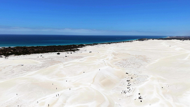 Aerial view of Lancelin Sand Dunes with white sand formations turquoise ocean coastline and clear blue sky in Lancelin Western Australia Australia. Aerial view of Lancelin Sand Dunes with white sand formations turquoise ocean coastline and clear blue sky in Lancelin Western Australia Australia.
