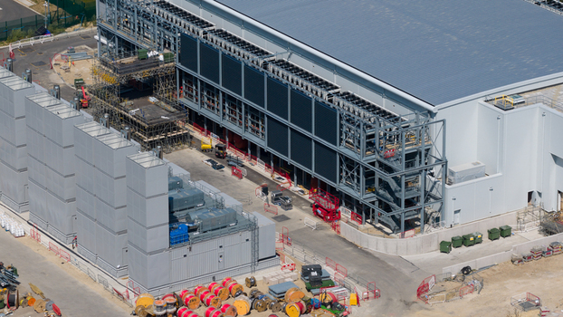Aerial view of the Kao Data facility featuring industrial infrastructure cooling units and ongoing construction work in Harlow England United Kingdom. Aerial view of the Kao Data facility featuring industrial infrastructure cooling units and ongoing construction work in Harlow England United Kingdom.