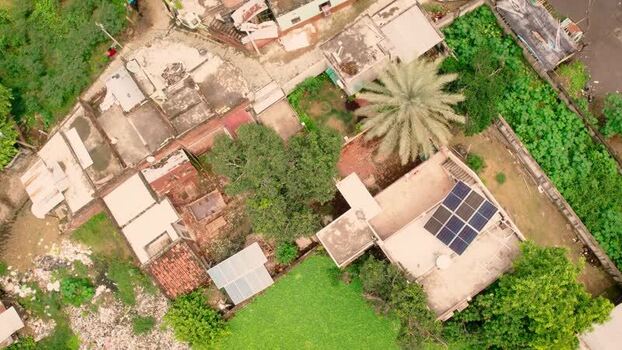 Aerial view of solar panels on a rooftop in India.
