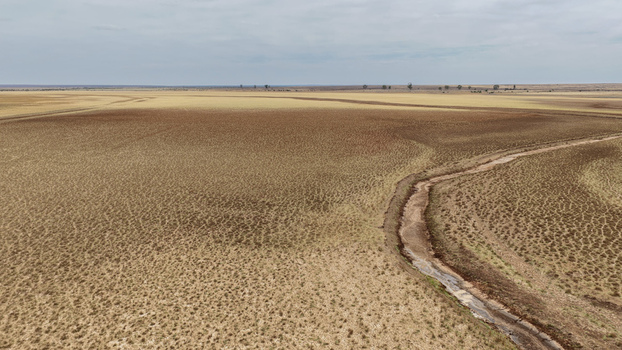 Aerial view of a drought stricken landscape with barren farmland parched vegetation and a dry river channel Beaufort West Western Cape South Africa. Aerial view of a drought stricken landscape with barren farmland parched vegetation and a dry river channel Beaufort West Western Cape South Africa.