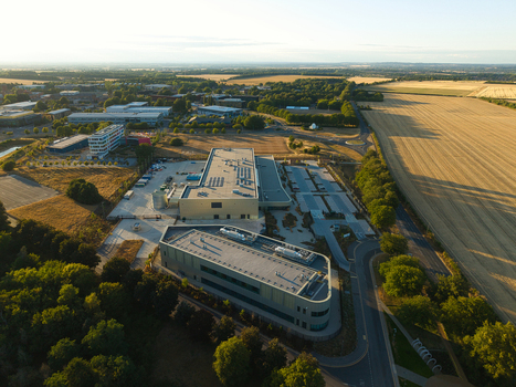 Aerial view of the Moderna Innovation and Technology Centre surrounded by rural fields modern office buildings and parking areas in Harwell Oxford England United Kingdom.